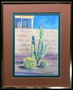 Cactus in an Arizona Yard is an original watercolor pencil artwork by L.K. Steinbach. This art depicts three cactus in front of a light brown brick wall on a sunny day with a blue sky.